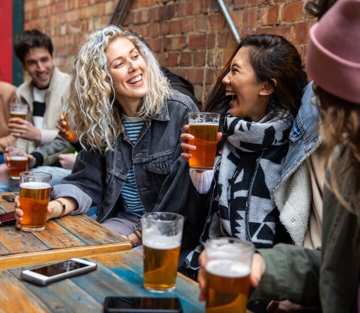 Friends enjoying a drink together while playing Treasure Hunt Cambridge